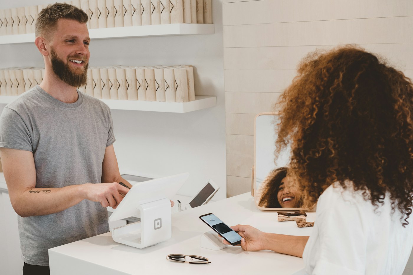 A salesperson talking with a customer across a shop counter